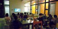The participants enjoying the local movie <i>Echoes of the Rainbow</i> at the International Movie Night